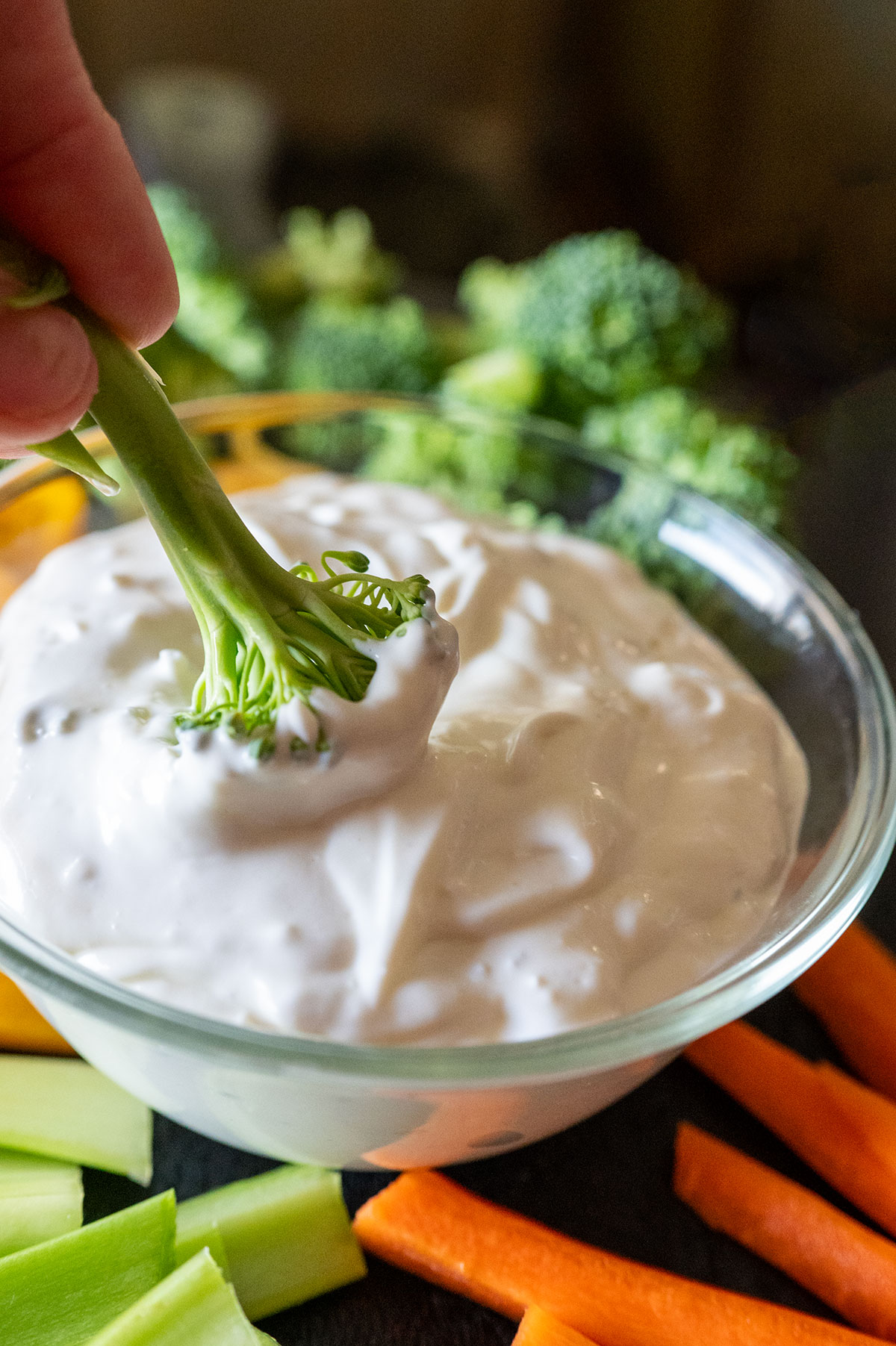 Dunking broccoli in blue cheese dip. 