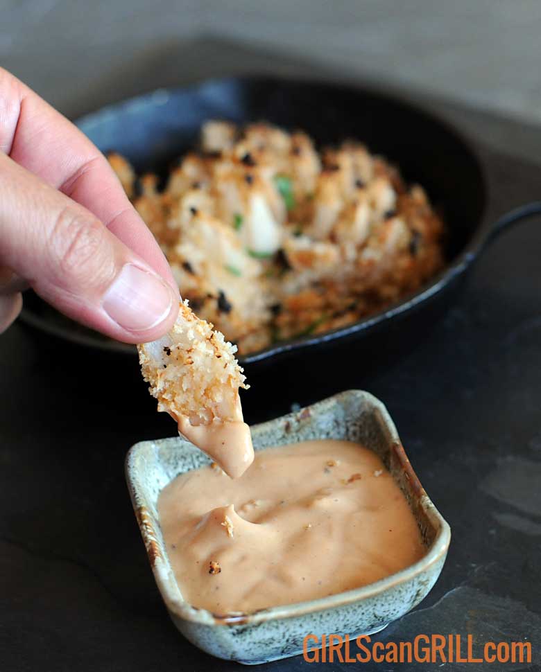 dipping blooming onion petal in sauce