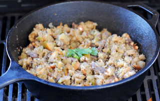 cast iron skillet with stuffing on grill