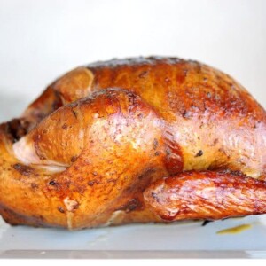 smoked turkey on white plate with white background