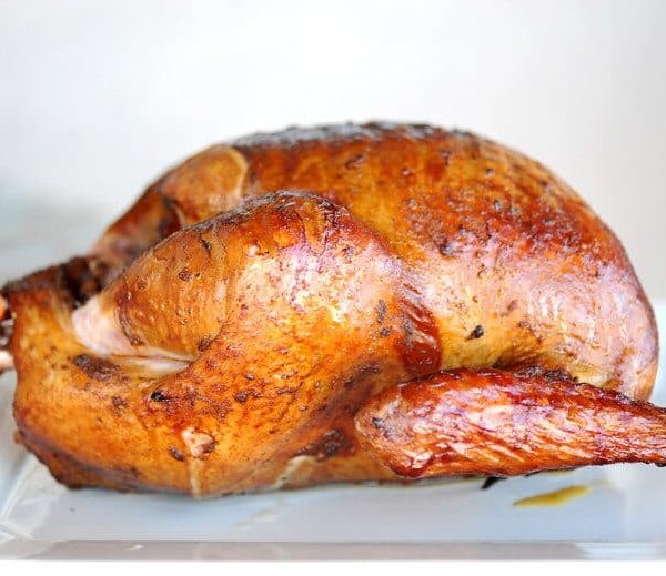 smoked turkey on white plate with white background