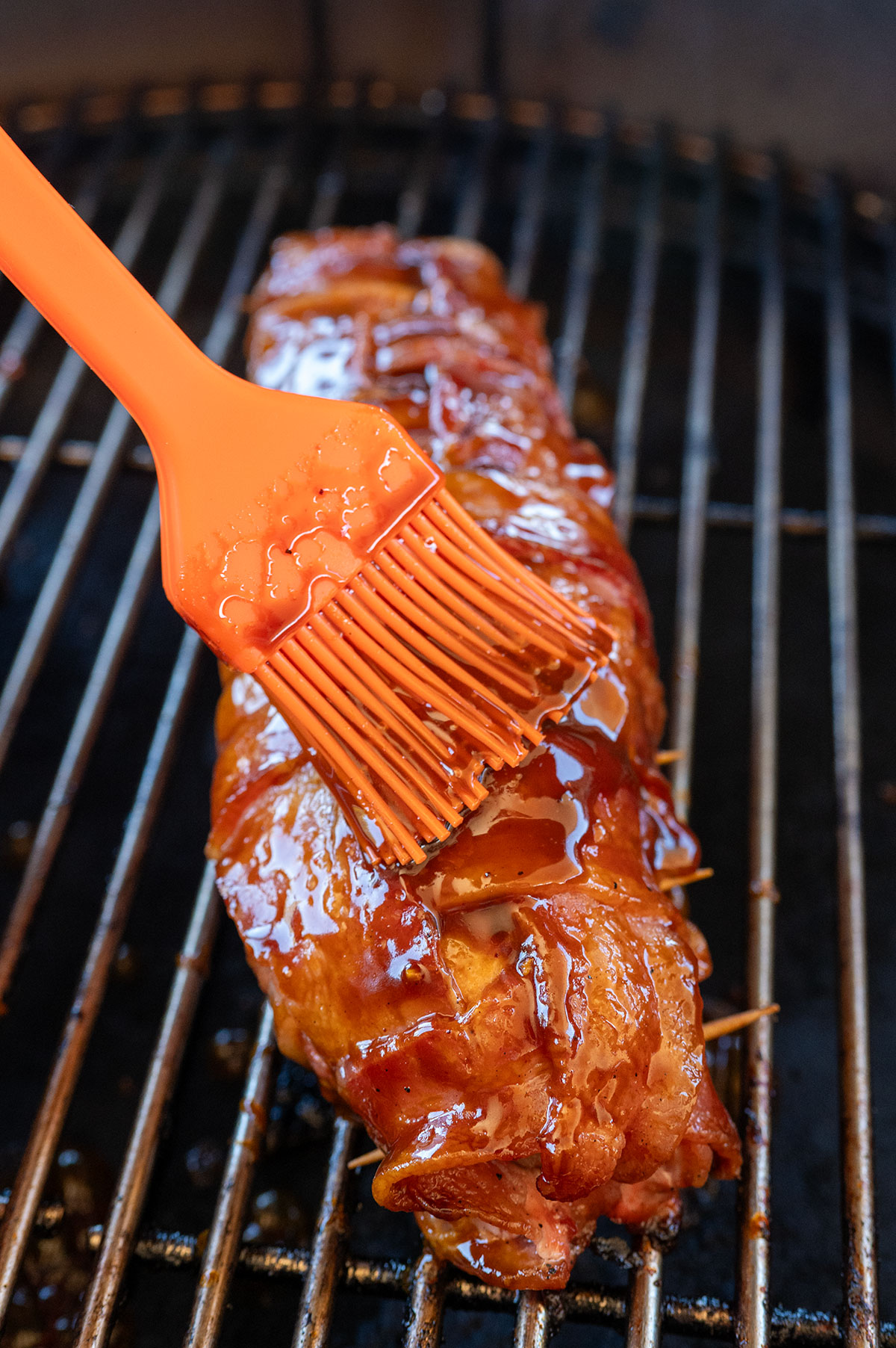 Basting glaze on bacon-wrapped pork tenderloin.