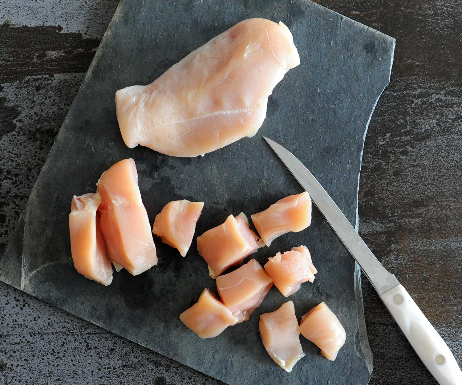 slicing chicken breast into nuggets