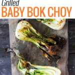 4 halves of grilled baby bok choy on slate.
