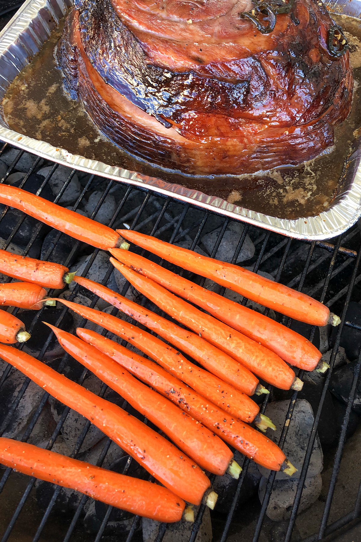 Carrots on grill next to ham.