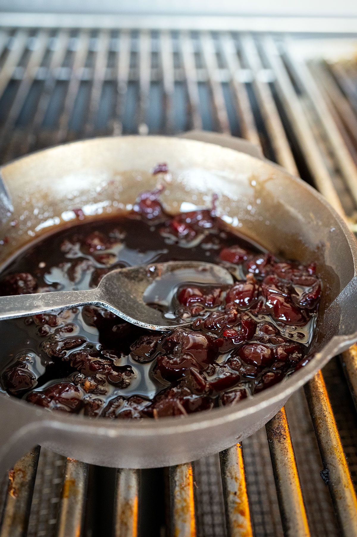 Cherry glaze in a skillet on grill.
