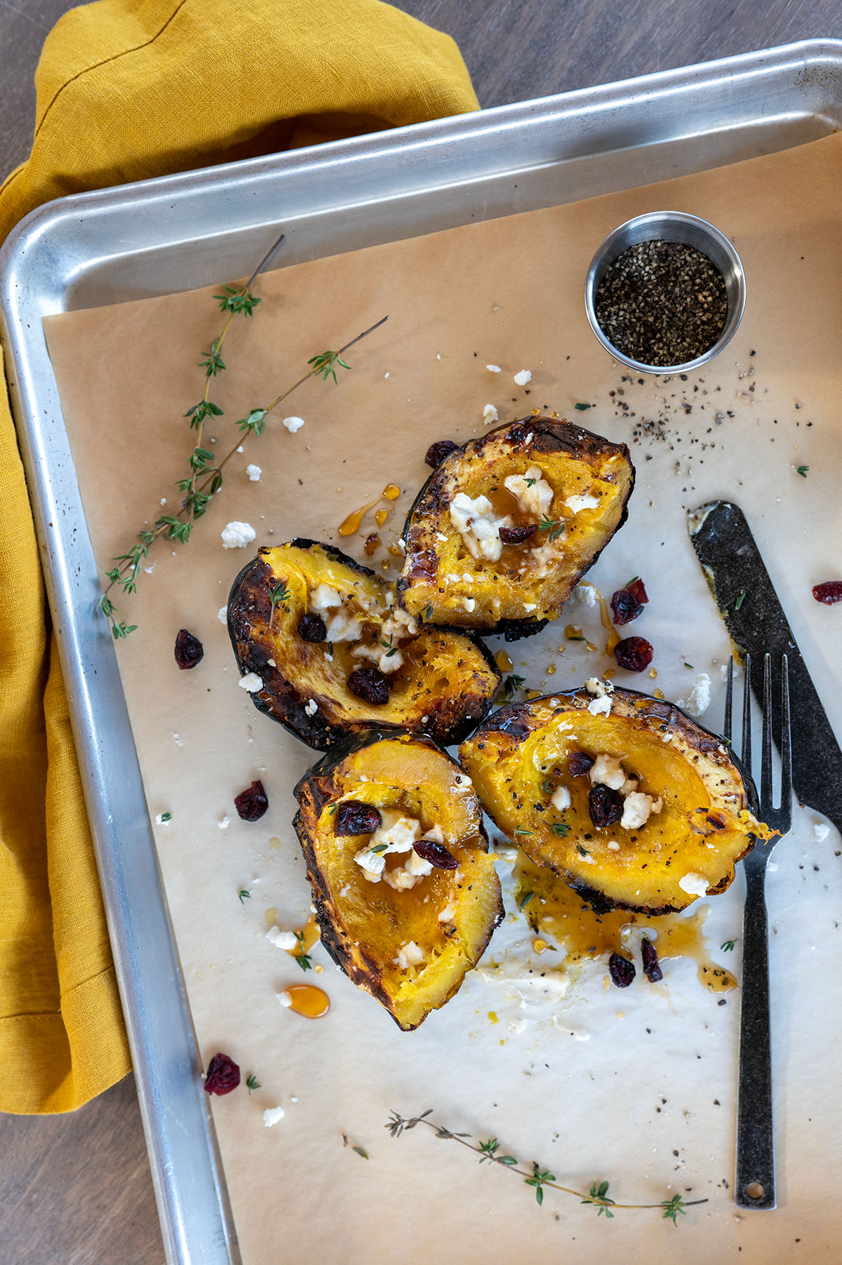 grilled acorn squash cut into quarters with goat cheese and cranberries.