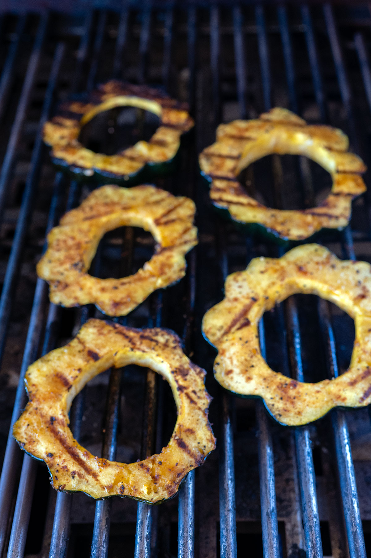 acorn squash on grill with grill marks.