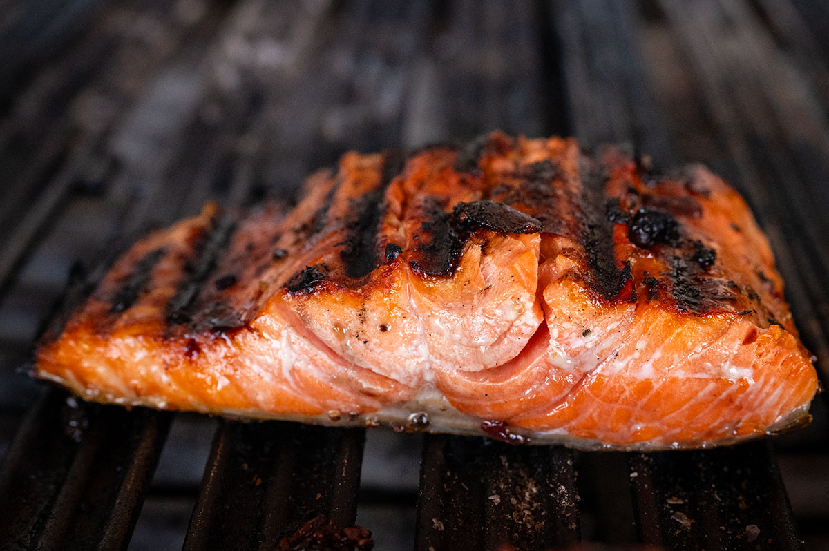 salmon on grill with char marks.