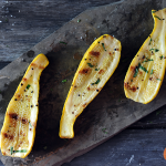 grilled yellow squash on slate background