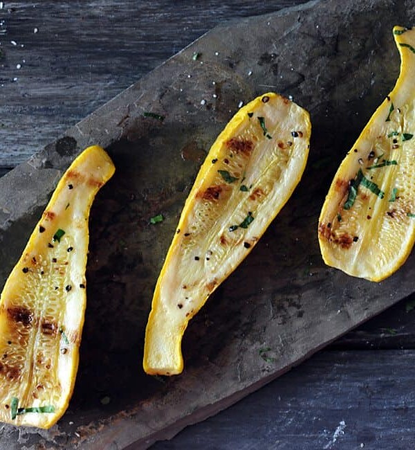 grilled yellow squash on slate background