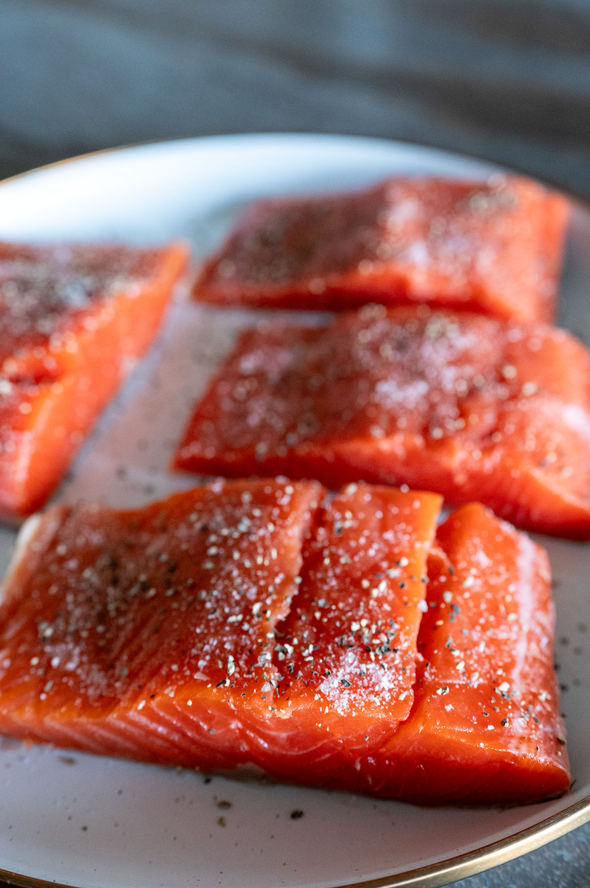 Salmon filets seasoned with salt and pepper.