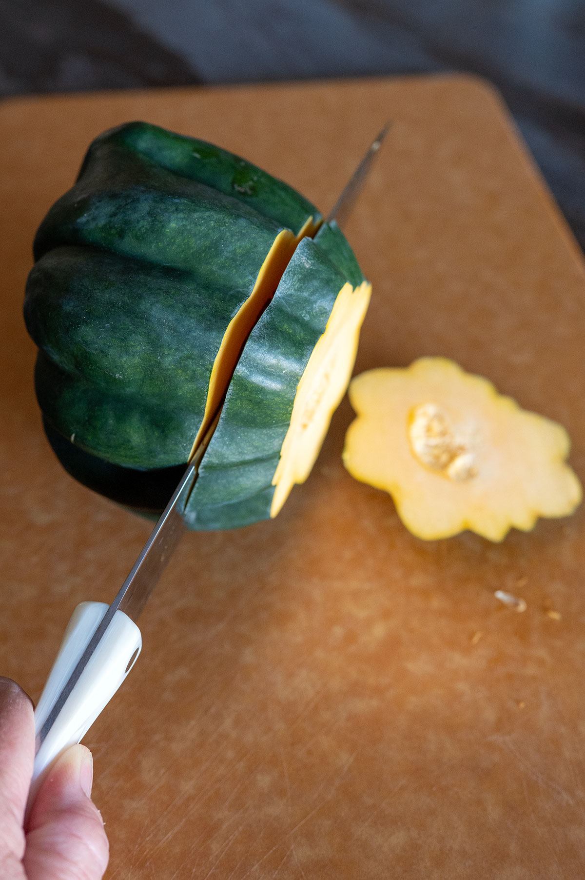 slicing acorn squash into half-inch rings.