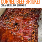 corn beef brisket on grill with charcoal to the side.