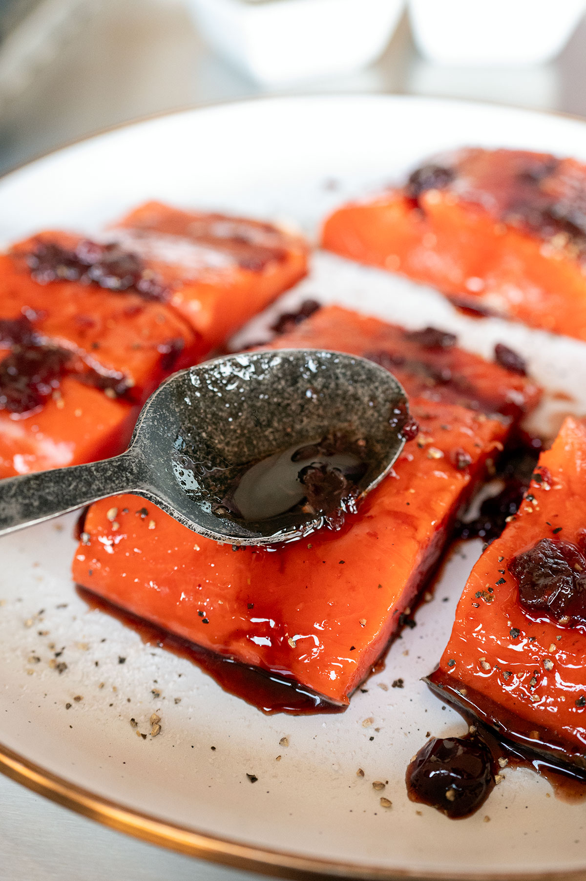Spooning cherry glaze on salmon.