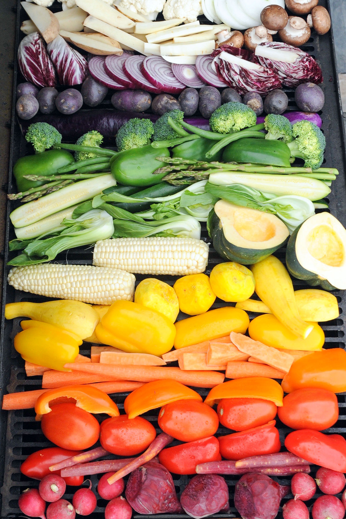 rainbow of fresh vegetables on a grill.