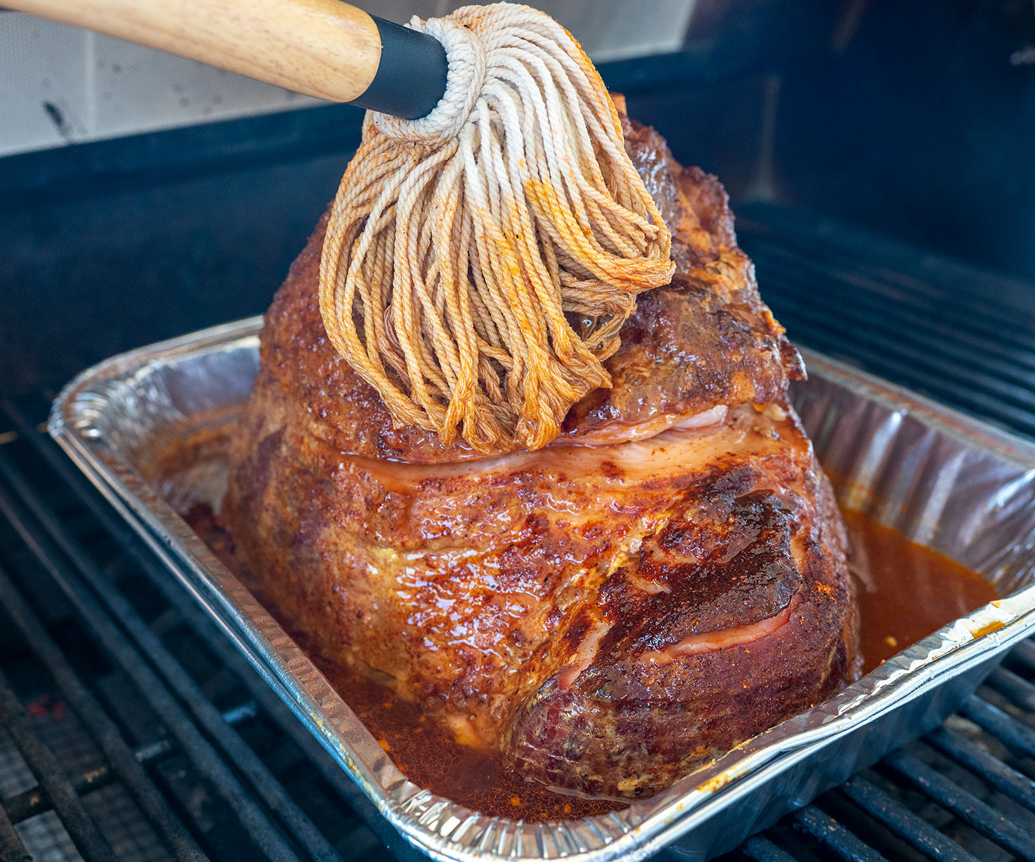 basting grilled ham with pan juices
