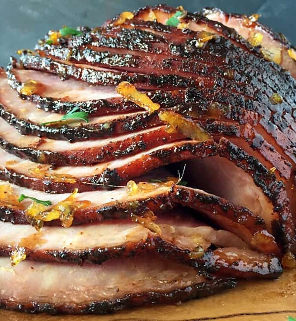 sliced grilled ham with glaze dripping down