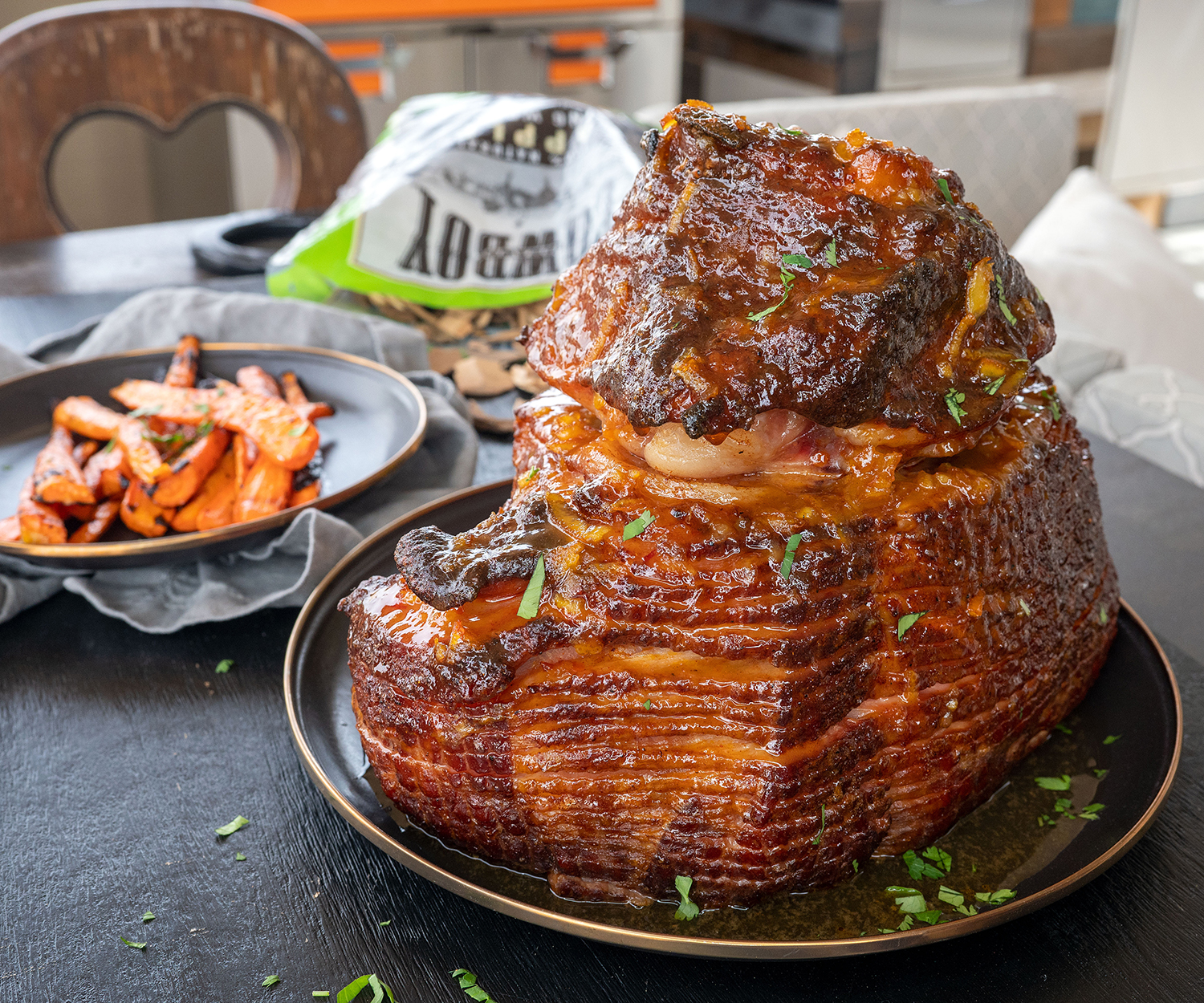 grilled ham on table with carrots and wood chips