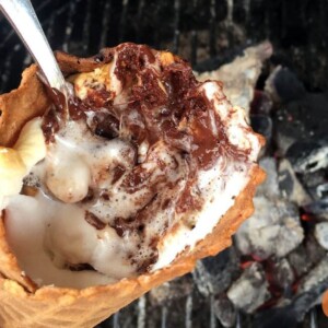 waffle cone near grill filled with melted chocolate and marshmallows