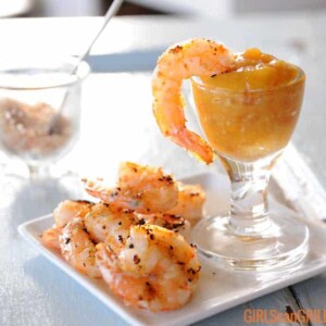 grilled shrimp on plate with one dipped in sauce