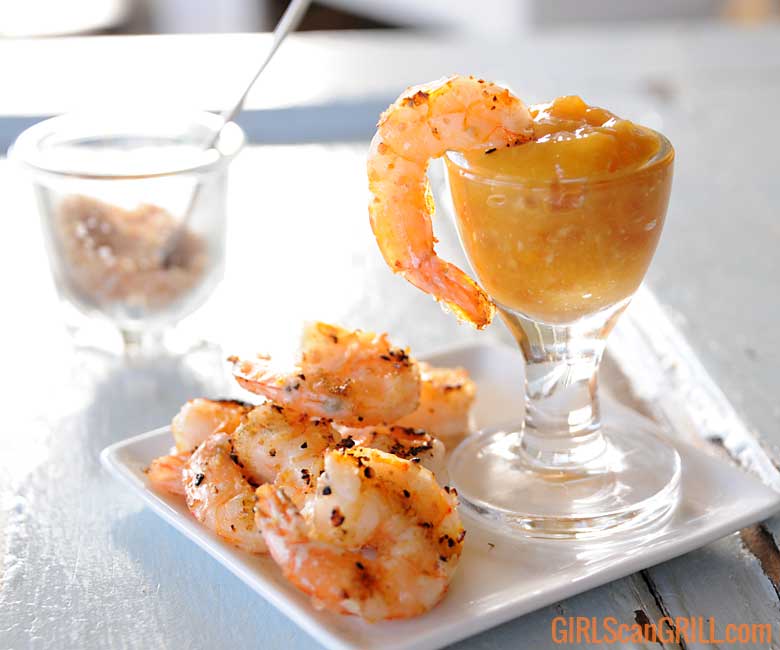 grilled shrimp on plate with one dipped in sauce