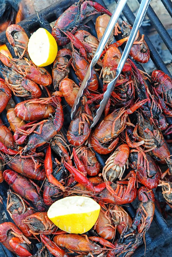 Cooking crawfish on a grill over fire.