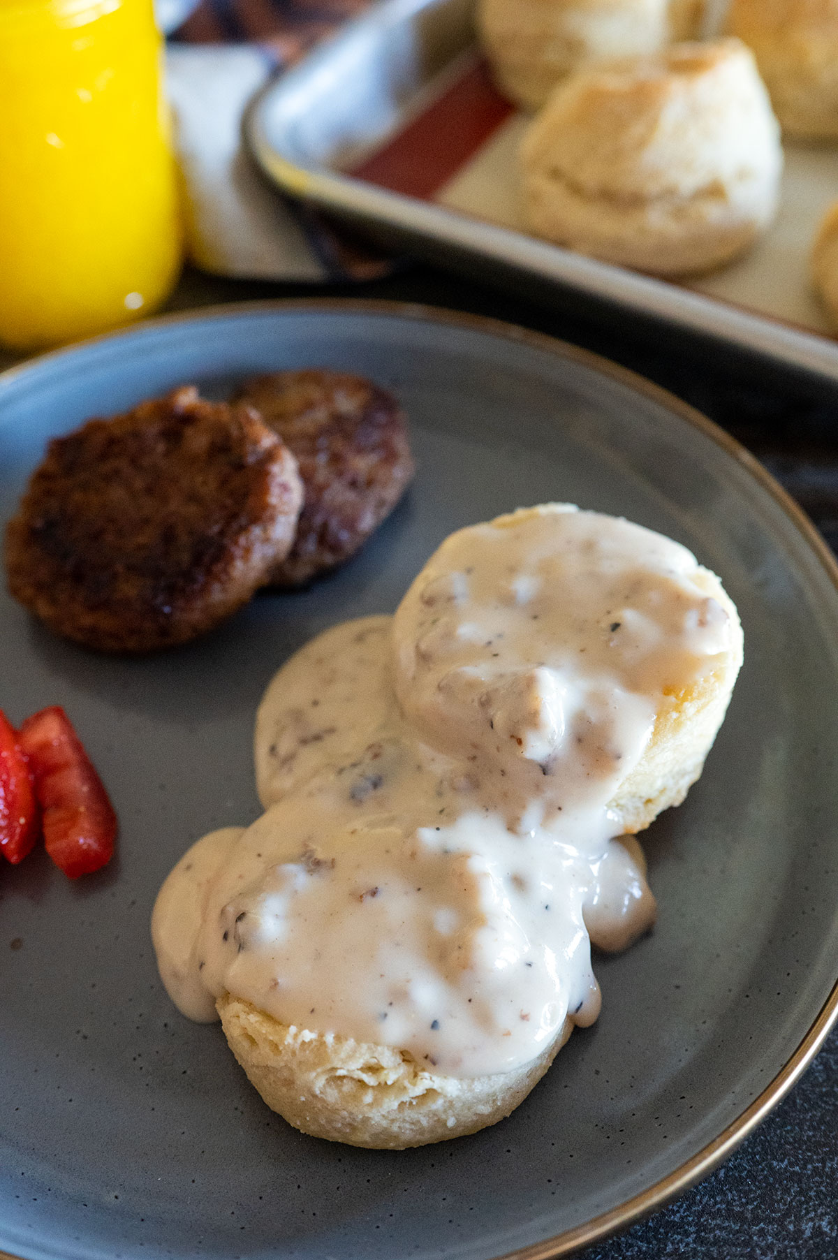 biscuits and gravy with sausage and tomatoes.