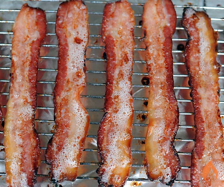 slices of homemade bacon cooked on a baking sheet