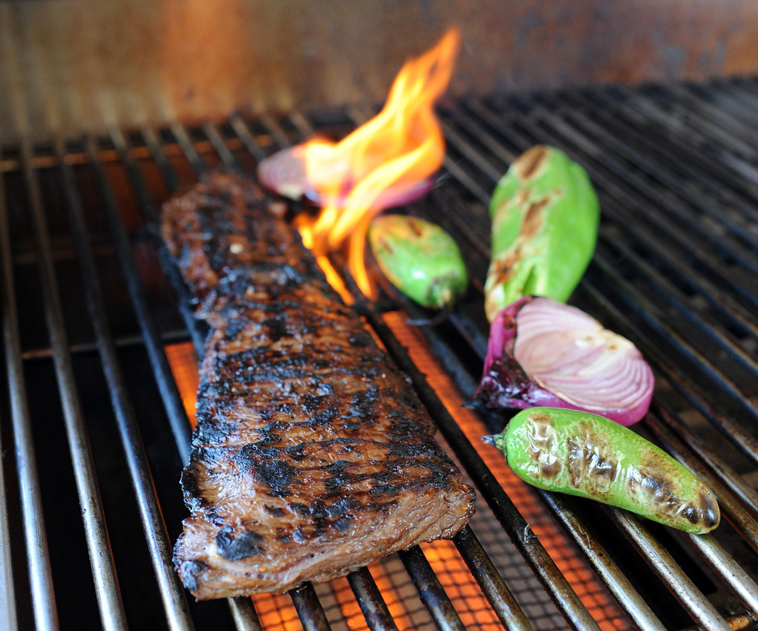 flame kissing a skirt steak on the grill