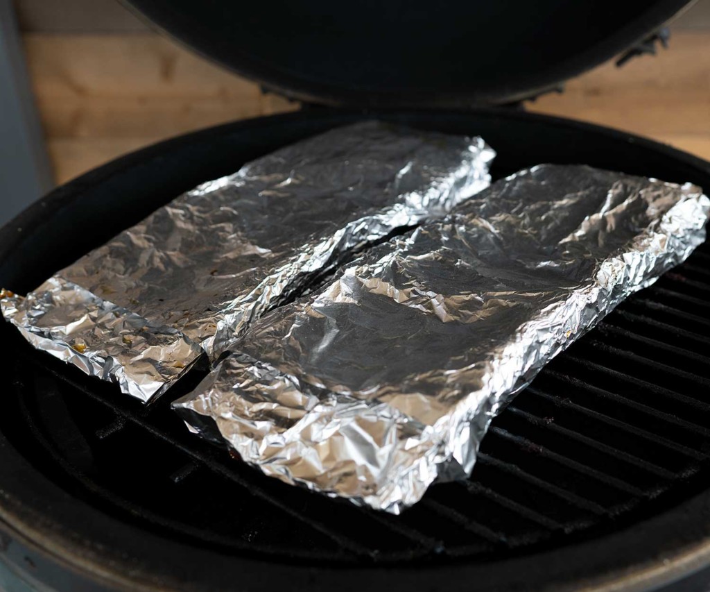 two racks of ribs wrapped in foil