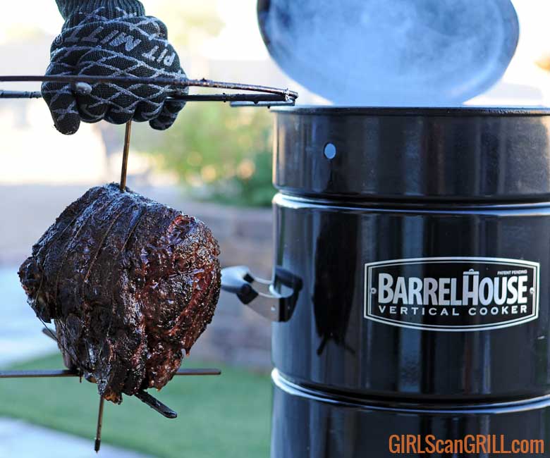 hand holding cooked prime rib roast hanging by Barrel House Cooker