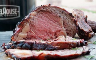 Prime Rib Roast Sliced with grill in background
