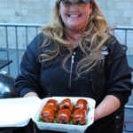 Female Pitmaster Christie Vanover holds a turn-in box filled with chicken