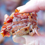 hand squeezing corned beef burnt end.