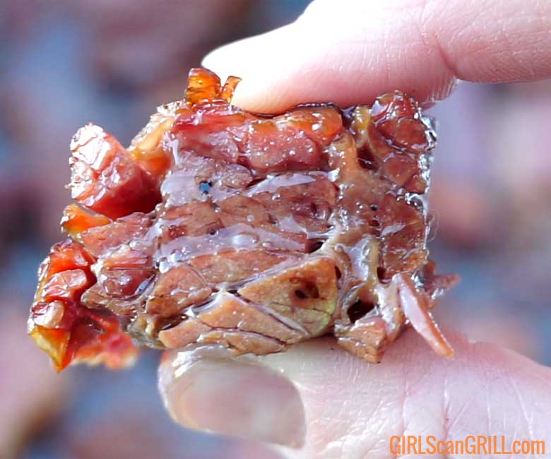 fingers squeezing corned beef burnt ends