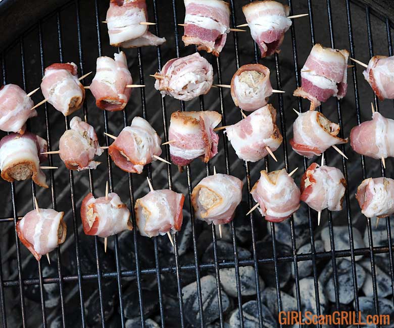 grill full of raw bacon-wrapped meatballs - moink balls