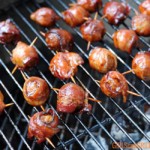 grill full of sauced bacon-wrapped meatballs