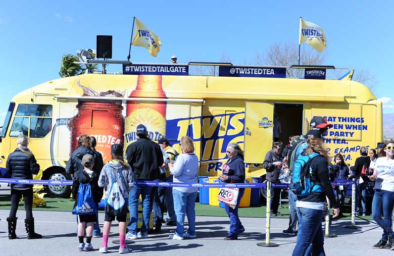 wide shot of twisted tea yellow rv with crowd