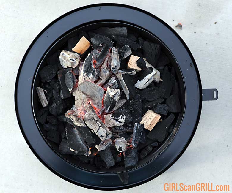 coal basket filled with lit lump charcoal and 3 wood chunks