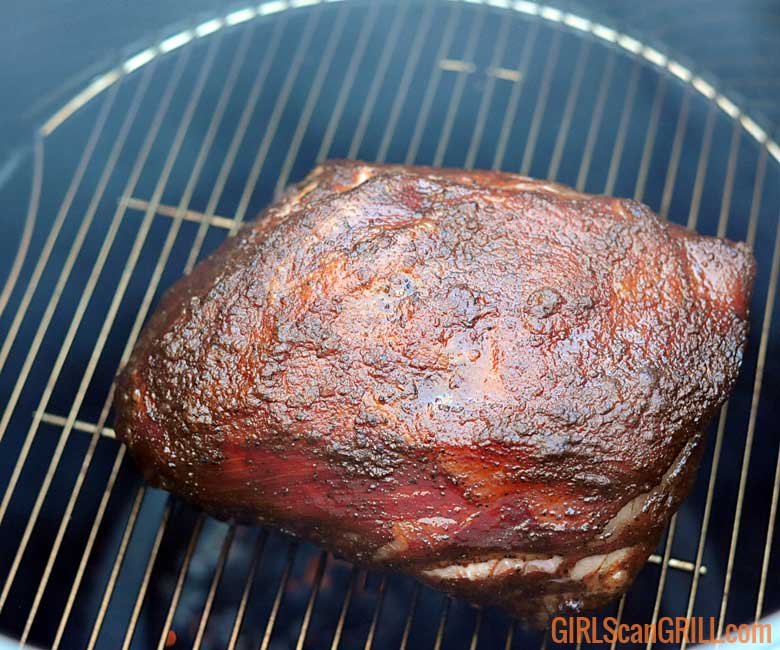 pork butt smoking on a grill rack