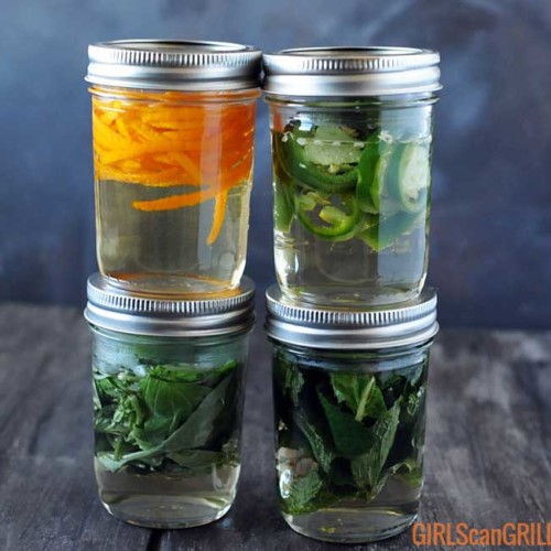 4 jars with herbs and simple syrup