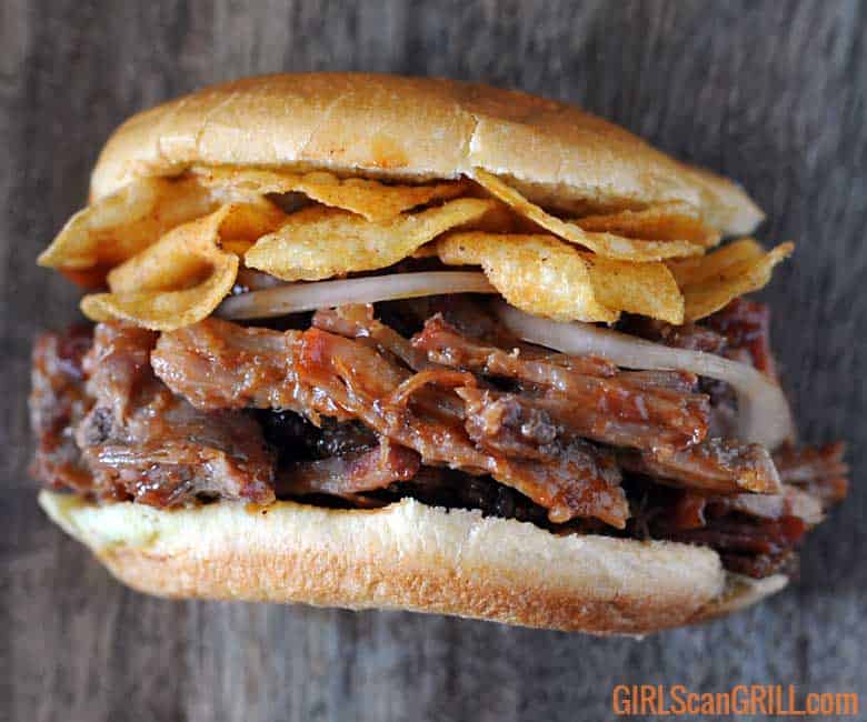 pulled pork sandwich with chips on top