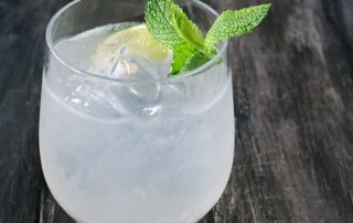 smoked mojito in glass on gray background with mint sprig