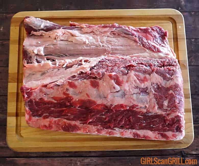 prime rib on cutting board showing seam between cap and filet
