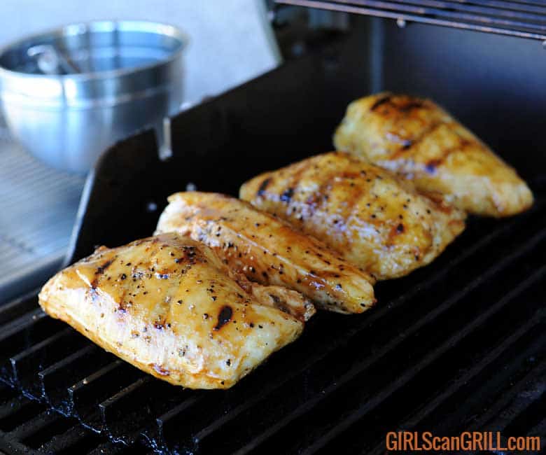 4 chicken breasts on grill with grill marks