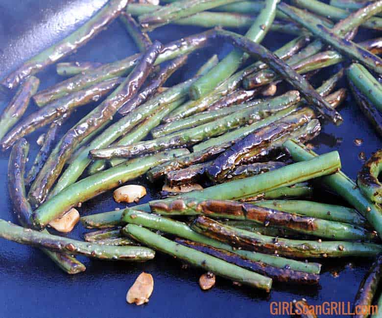 garlic green beans sauteeing in cast iron skillet