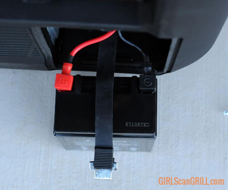red and black connectors attached to generator battery