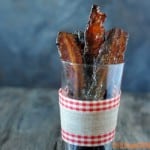 spicy mustard brown sugar bacon in glass with ribbon around it