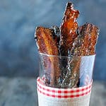 glass of cooked brown sugar bacon.